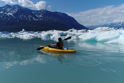 Older adult surrounded by children and grandchildren overlooking Alaska's majestic mountains and pristine waters